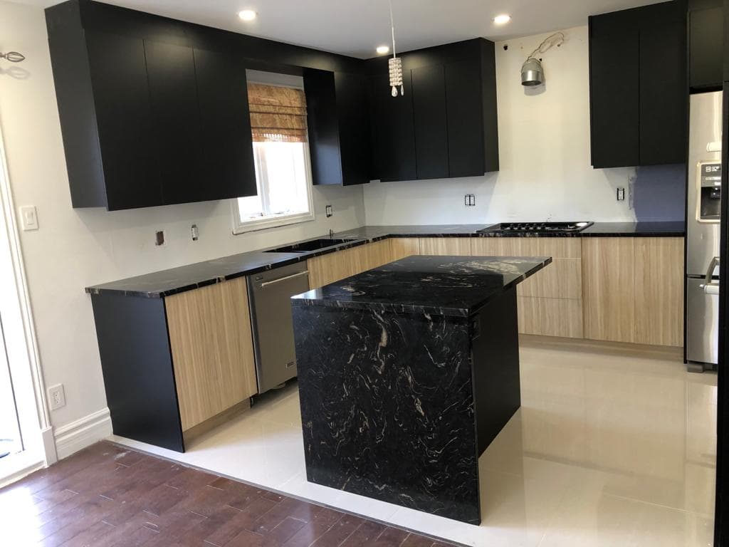 Two-tone matte black and light timber kitchen with black granite island