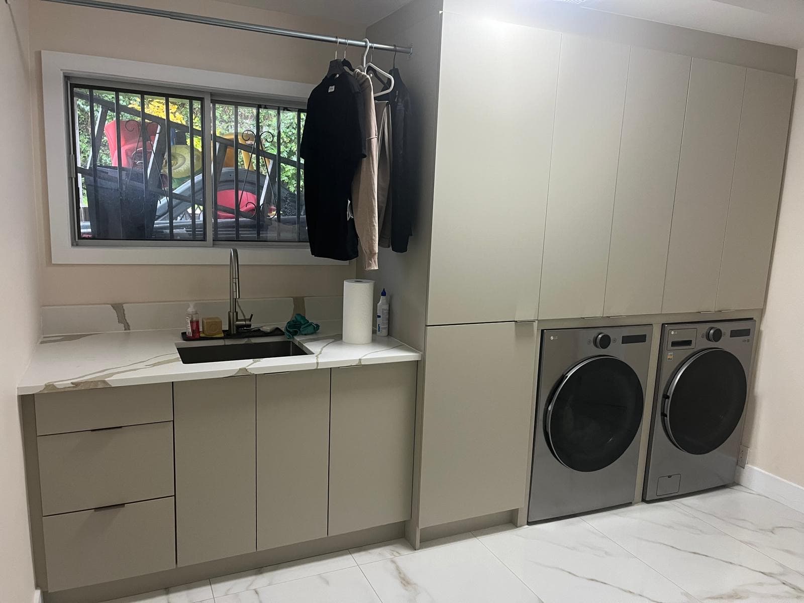 Taupe laundry room with calacatta quartz counter