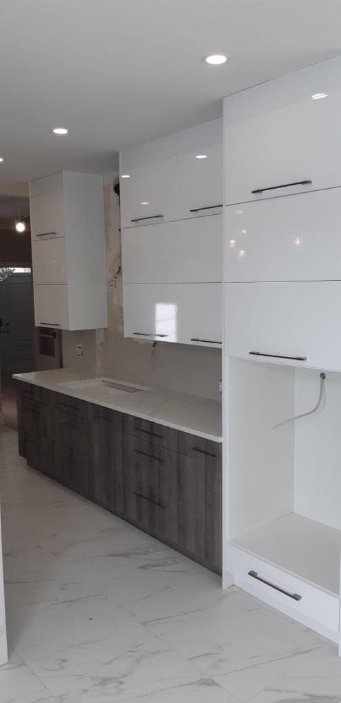 Two-tone gloss white and dark oak galley kitchen