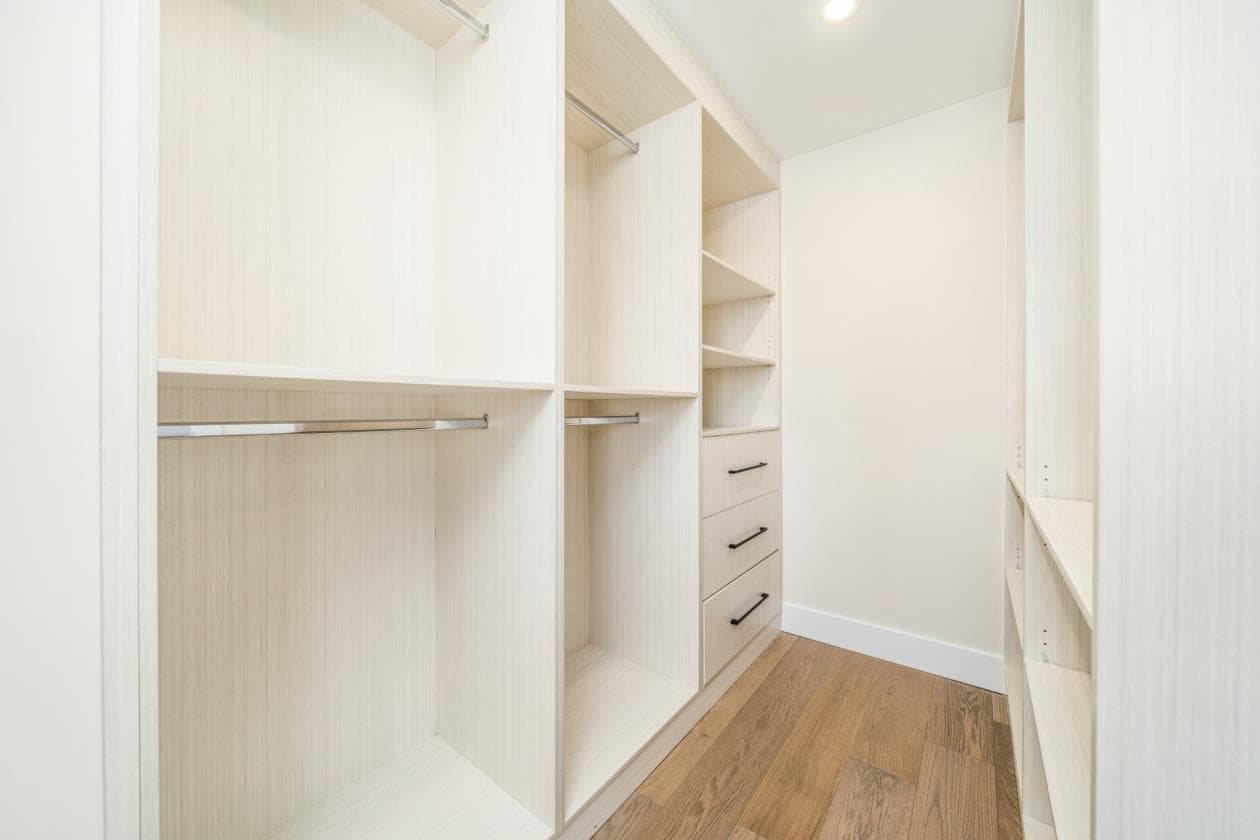 Custom walk-in closet in light wood with open shelving