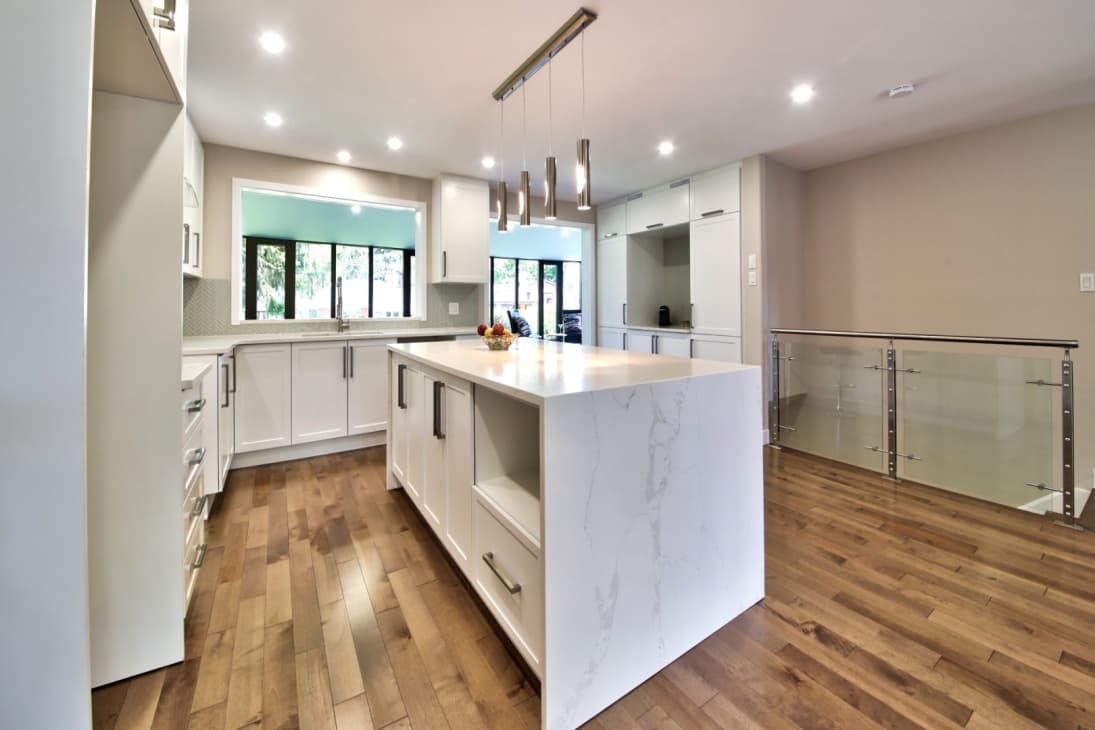 White kitchen with calacatta island and lateral pendant lights