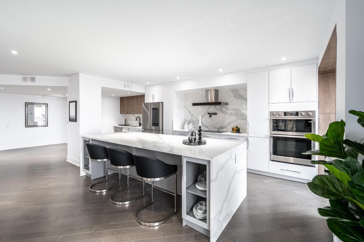 Open-plan kitchen with Calacatta island and bar seating
