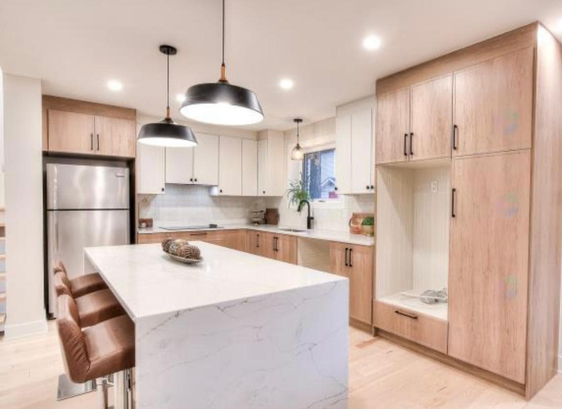 Two-tone light oak and white kitchen with Calacatta island